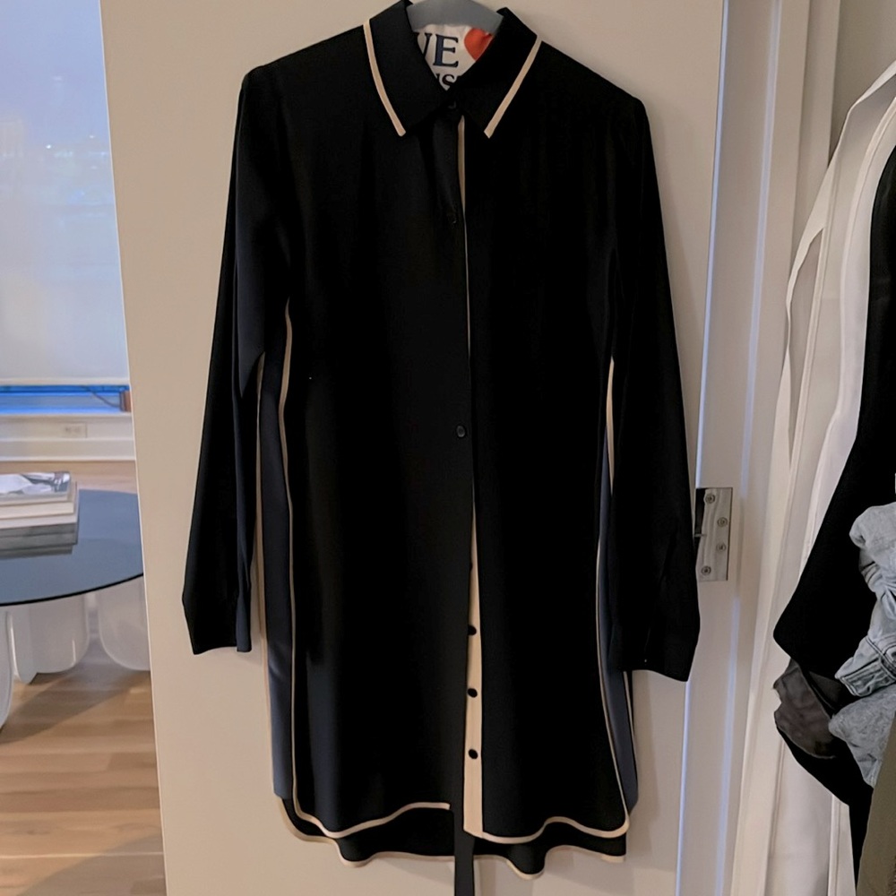 Navy blue shirt dress, with cream and light blue touches. Hangs above the knee.